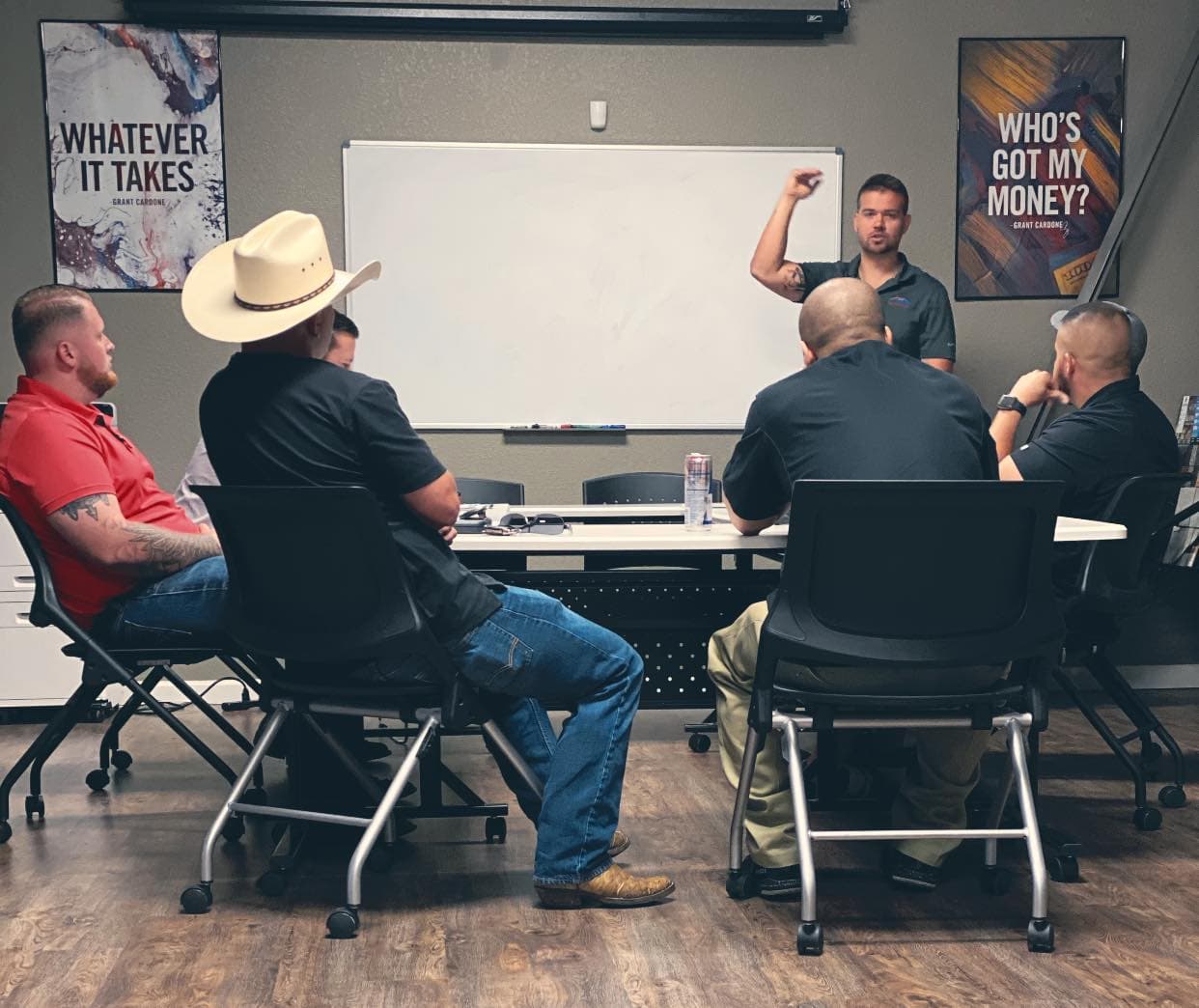 Business meeting with group discussing strategies in a conference room setting.